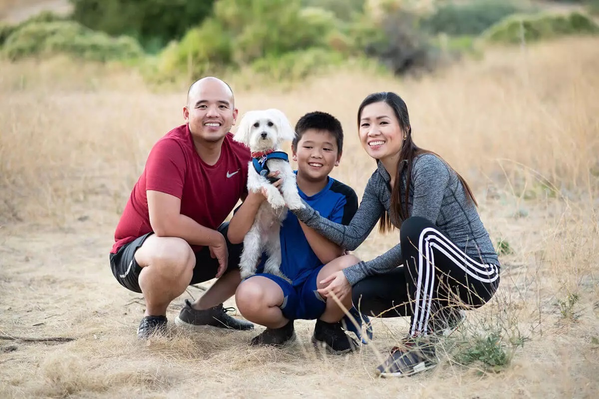 A family with their dog outside
