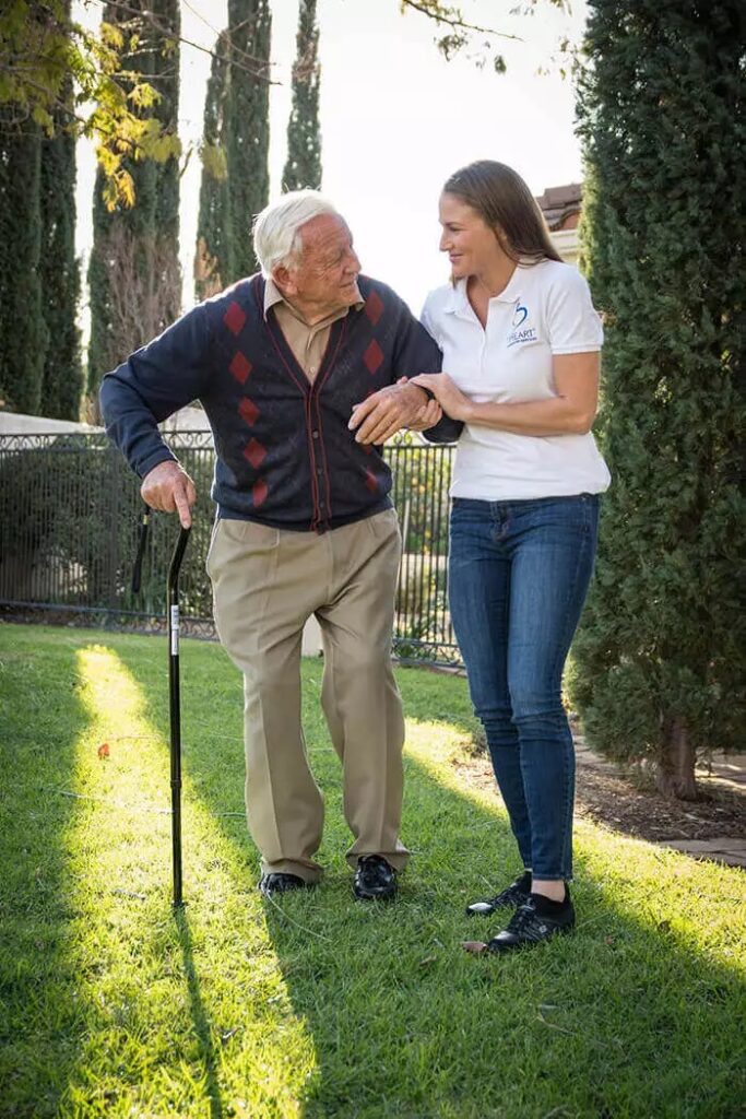 A person entering the homecare market by helping an elderly person walk