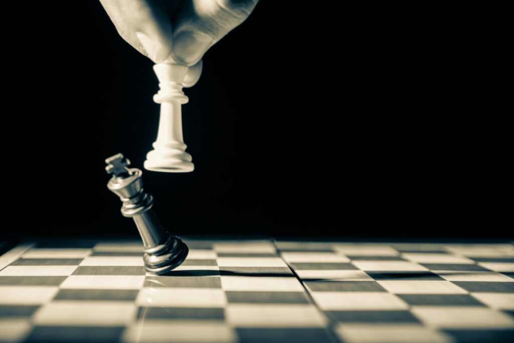 White king taking out black king during a game of chess