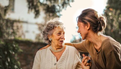 A woman speaking to an older individual after exploring homecare franchise opportunities in 2024