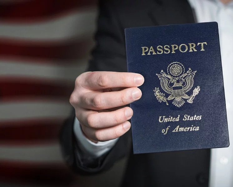 A person holding a passport for someone who applied for an E2 visa franchise