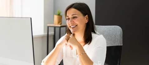 Person smiling at computer
