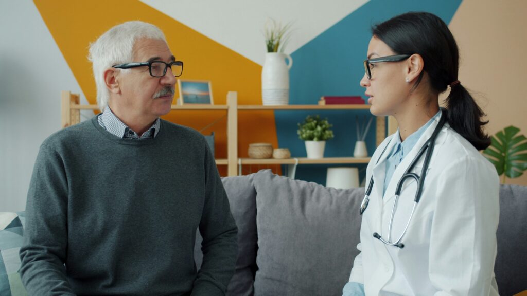 Doctor visit showing difference between home care and home health at patient home